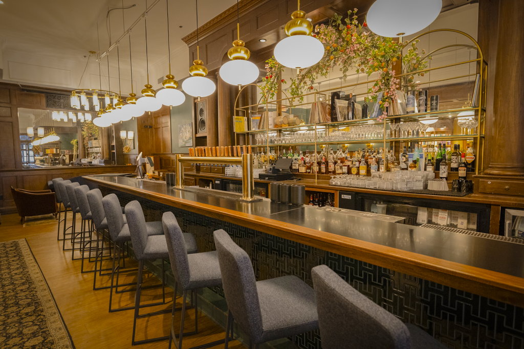 The Guild sip-and-read bar with seating, shelves, and warm lighting